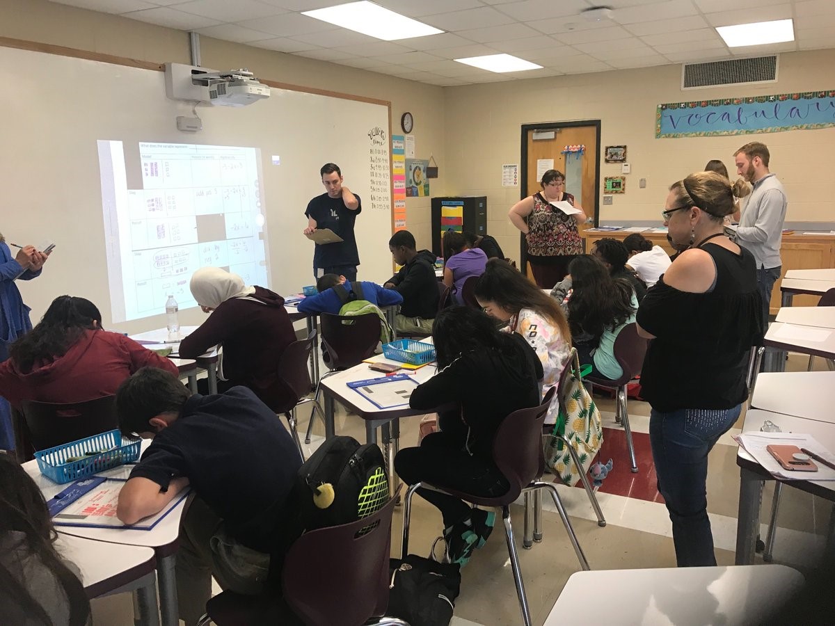 Group of teachers working on lesson plans in a classroom