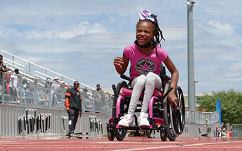 Student in wheelchair having fun at Region 10's Kid-netic games