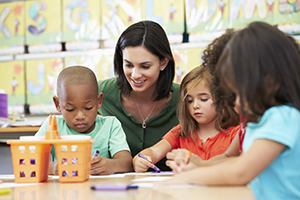 Teacher coloring with young students