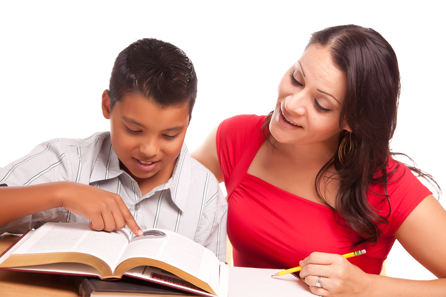 Woman helping a boy to read 