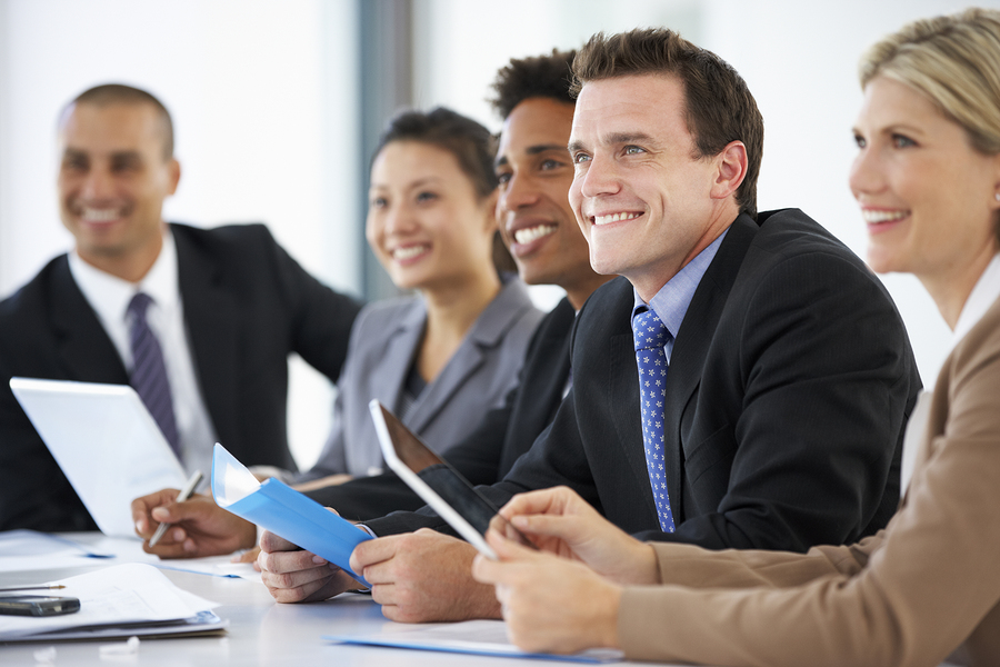 Group of business people watching and smiling