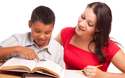 Hispanic mother helping son with homework