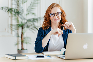 Woman smiling working at desk