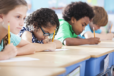 Students taking a test, girl thinking