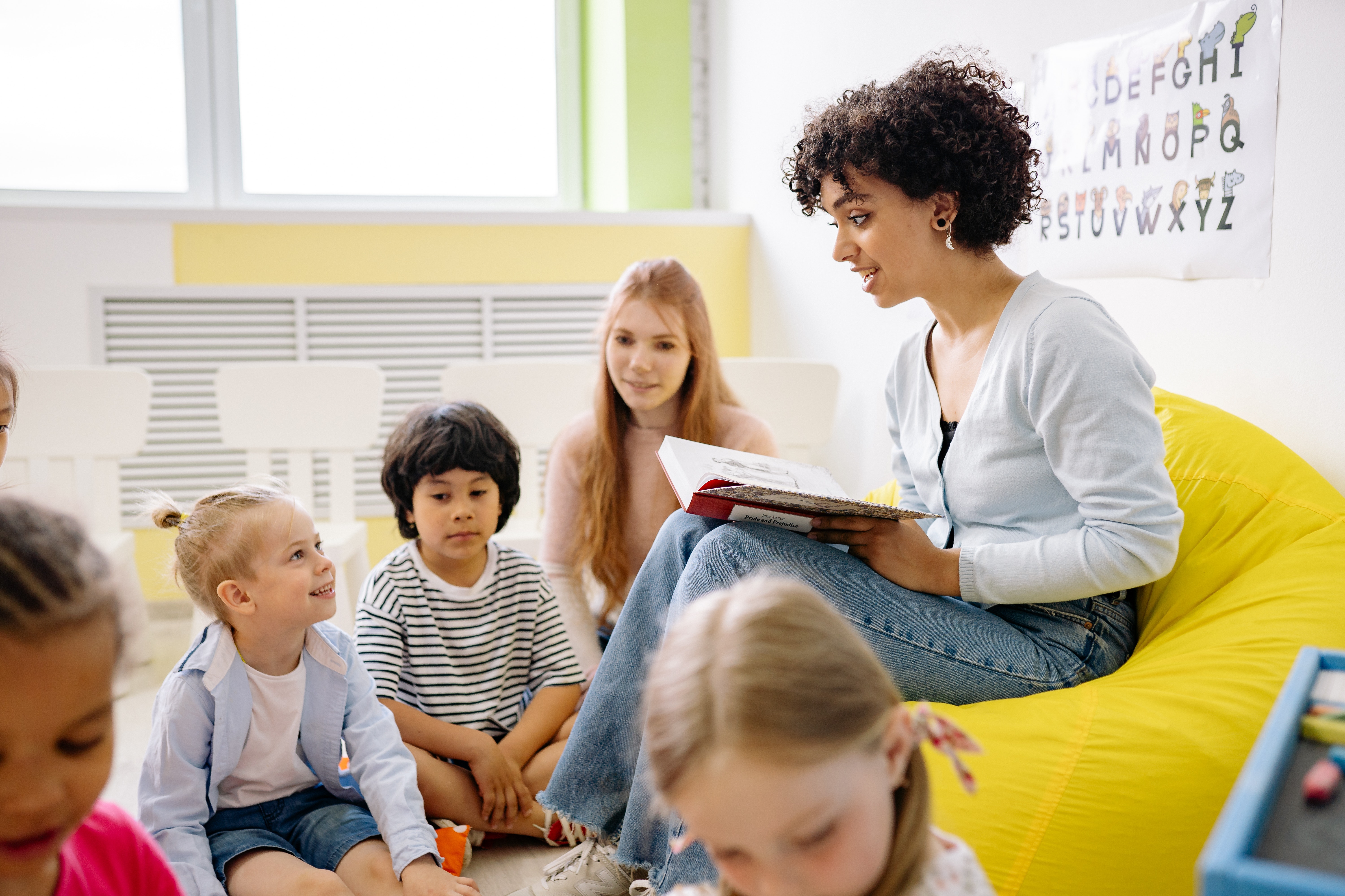 Teacher reading book to students